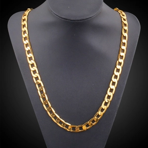 Classic gold-plated Figaro curb chain necklace displayed on a black bust stand
