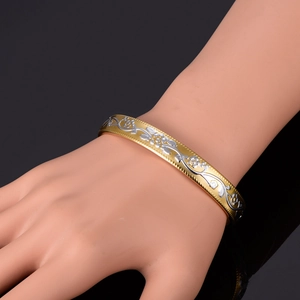 Exquisite 18K gold and silver two-tone cuff bracelet with embossed floral vine patterns
