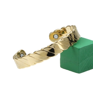 Bracciale rigido a torchon placcato oro 18K con magneti terapeutici su sfondo bianco