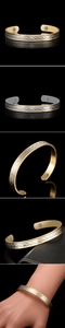 Close-up of dual-tone magnetic health bracelet with wave pattern and inset magnets