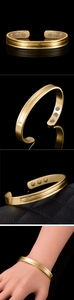 Detail of 18K gold plated magnetic therapy cuff with wave texture and six inset magnets