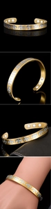 Detail of 18K gold magnetic therapy bracelet with thunderbird relief and inner magnets