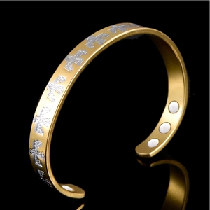 18K two-tone magnetic therapy cuff bracelet with golden finish and silver eagle motifs