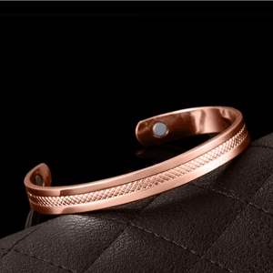 Rose gold magnetic therapy bracelet with diamond grid pattern on black leather