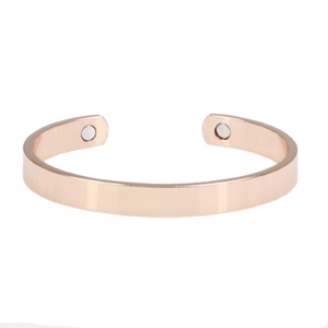 Macro detail of rose gold magnetic therapy copper bracelet with smooth polished finish