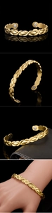 Detail of 18K gold braided magnetic therapy bracelet featuring inner magnetic stone inserts