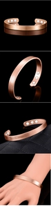 Detail of rose gold magnetic therapy cuff showing inner magnets and parallel texture