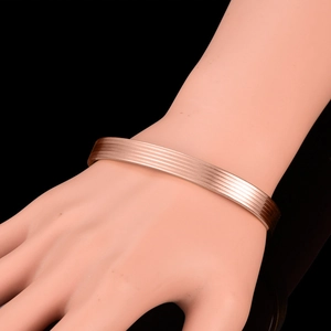 Rose gold magnetic therapy open cuff bracelet with minimalist brushed metal grooves