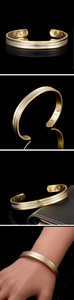 Detail of 18K gold open bangle with magnetic therapy stones and silver mesh texture