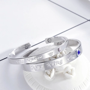 Detail of his and her crown engraved magnetic couple bracelets with zircon stones