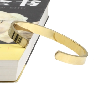Polished gold-plated open cuff bracelet with C-shaped minimalist design for women