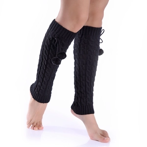Thick black cable knit leg warmers with drawstring pom-poms for winter boots