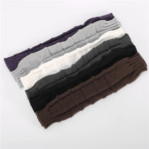 Close-up of knit arm warmers in six colors showing chunky block texture and ribbed cuffs