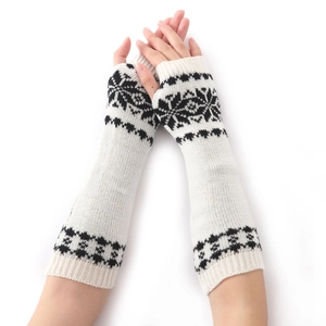 Dettaglio di guanti senza dita in maglia crema con motivi a fiocco di neve nordici