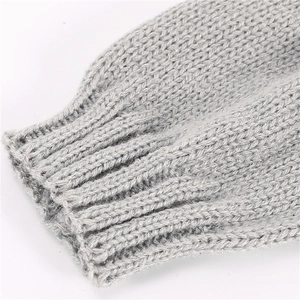Macro shot of grey ribbed knit cuffs with soft texture for warm winter gloves