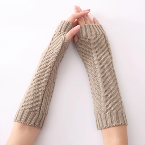 Detail of grey knitted arm warmer with herringbone texture and ribbed cuff design