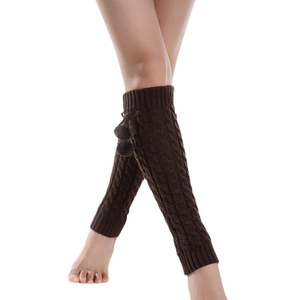 Thick cable knit leg warmers in dark brown with pom-pom accents for winter styling