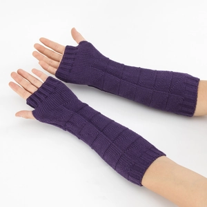 Detail of long purple knit fingerless gloves with diamond patterns and ribbed cuffs