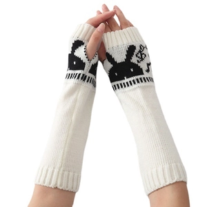 White knitted arm warmers with black rabbit pattern and fingerless thumb hole design