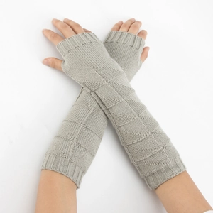 Macro view of grey knit arm warmers with diamond pattern and ribbed cuffs detailing