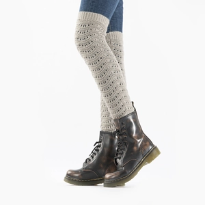 Detail of light gray knit leg warmers featuring hollow wave patterns and ribbed cuffs