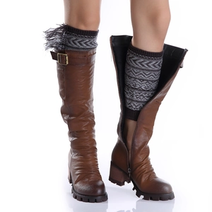 Brown leather high boots with bohemian fringed knit leg warmers and geometric patterns