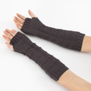 Detail of dark grey knitted fingerless arm warmers with a textured grid pattern