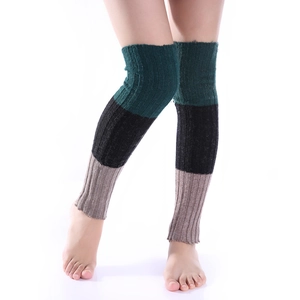 Detail of three-color block knit leg warmers in green, black, and beige ribbed texture