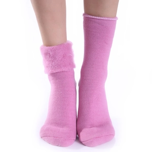 Detail of pink thermal socks with soft faux fur cuffs and cozy knitted texture