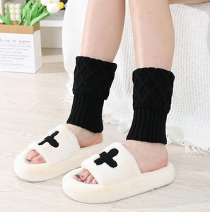 Detail of plush platform open-toe slippers with diamond-patterned knit leg warmers