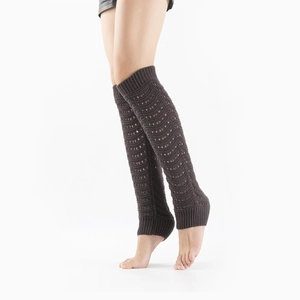 Detail of dark coffee knit leg warmers with hollow crochet patterns and ribbed cuffs