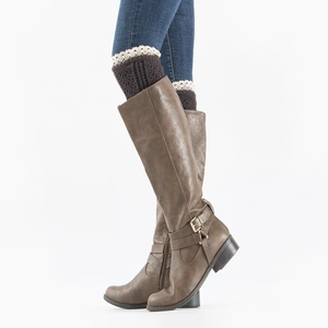 Close-up of knit dark brown boot cuffs with white lace trim worn over blue jeans