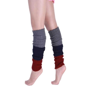 Detail of three-color knit leg warmers with vertical ribbed texture in gray, navy, and burgundy