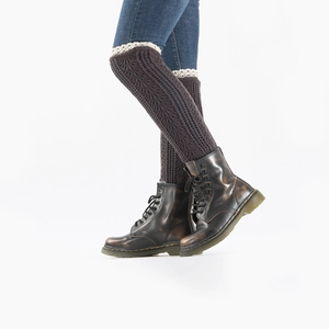 Detail of coffee knit leg warmers with white lace trim worn with vintage leather boots