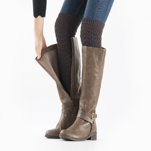 Detail of coffee brown crochet knit leg warmers paired with dark brown leather tall boots
