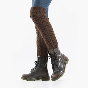 Detail of brown chunky knit leg warmers with hollow patterns and vintage boots