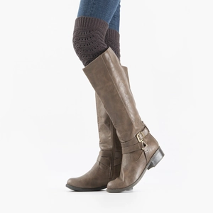 Detail of dark brown knitted leg warmers styled with premium brown leather boots