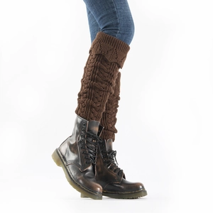 Close-up of brown cable knit leg warmers with textured hollow mesh and over-knee length
