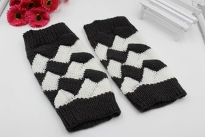 Detail of black and white checkerboard knit arm warmers with thick textured weave