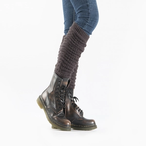 Detailed knit texture of dark brown leg warmers paired with classic brown leather boots