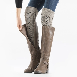Close-up of khaki hollow knit leg warmers with retro texture and high boots