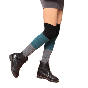 Detailed knit texture of three-color patchwork thigh-high leg warmers with boots