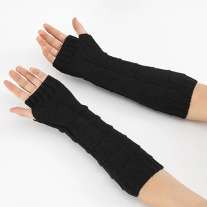 Detailed view of black knit arm warmers with square texture and ribbed cuffs