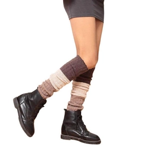 Detailed knit texture of three-color patchwork leg warmers with ribbed wool finish