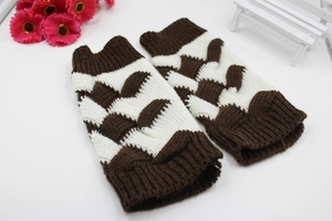 Detailed knit texture of brown and beige fingerless gloves with a wavy crochet pattern