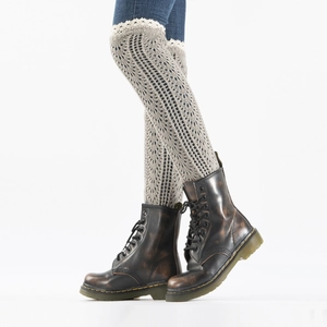 Detail of light grey knit leg warmers with delicate white lace trim over vintage boots