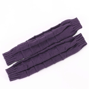 Macro view of dark purple knitted arm warmers with square texture and ribbed cuffs