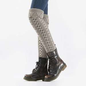 Detail of grey hollow knit leg warmers showing crochet texture with vintage boots