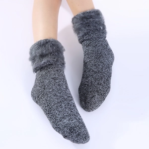 Close-up of thick grey faux fur trim on winter knit thermal socks for extra warmth