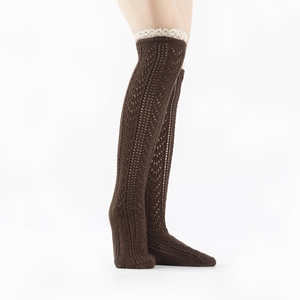 Detailed knit texture of dark brown leg warmers with white lace trim and hollow crochet